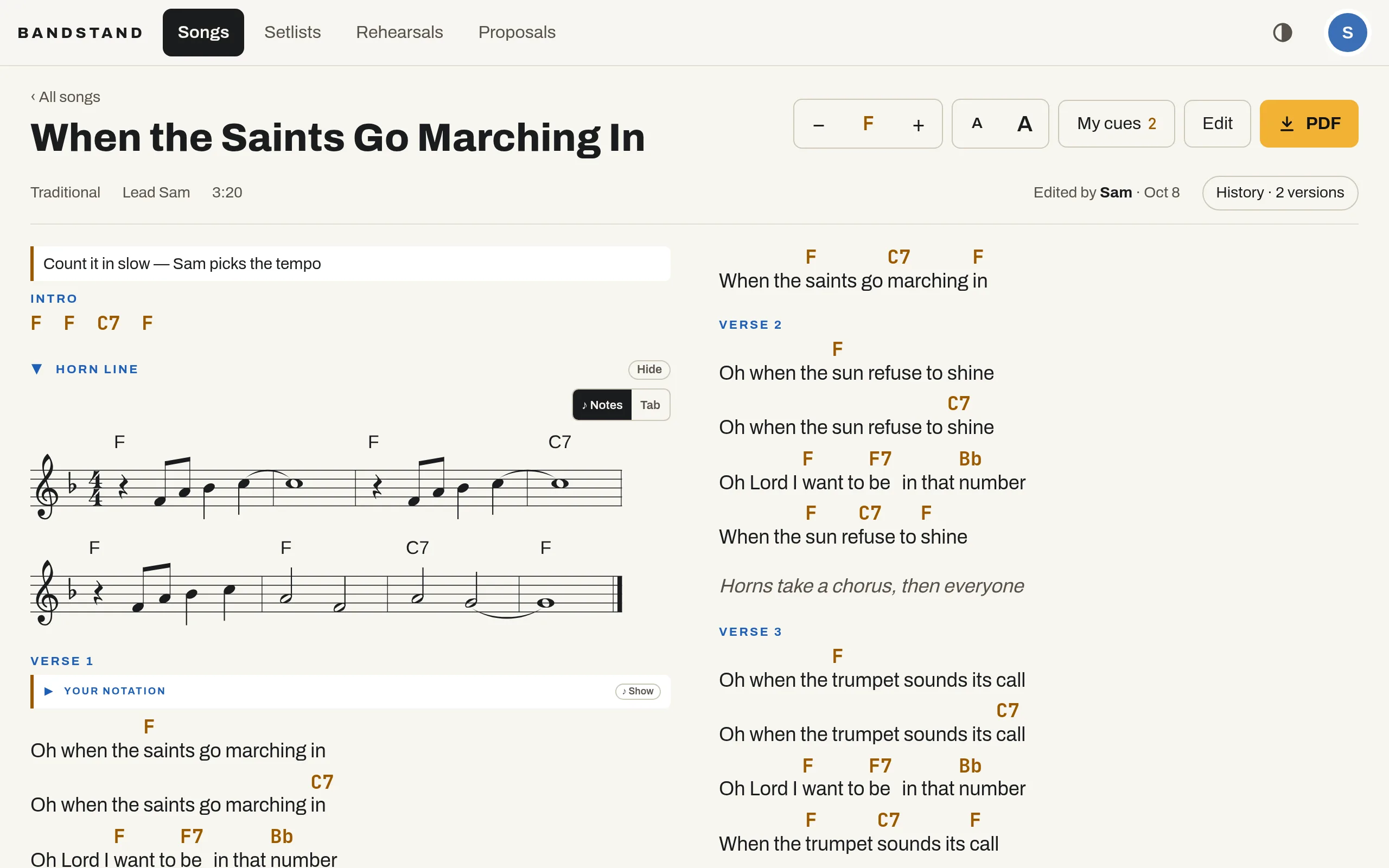 A song page: When the Saints Go Marching In in F, with key and text-size controls, the horn line written out as notation, and chords in amber over the lyrics.