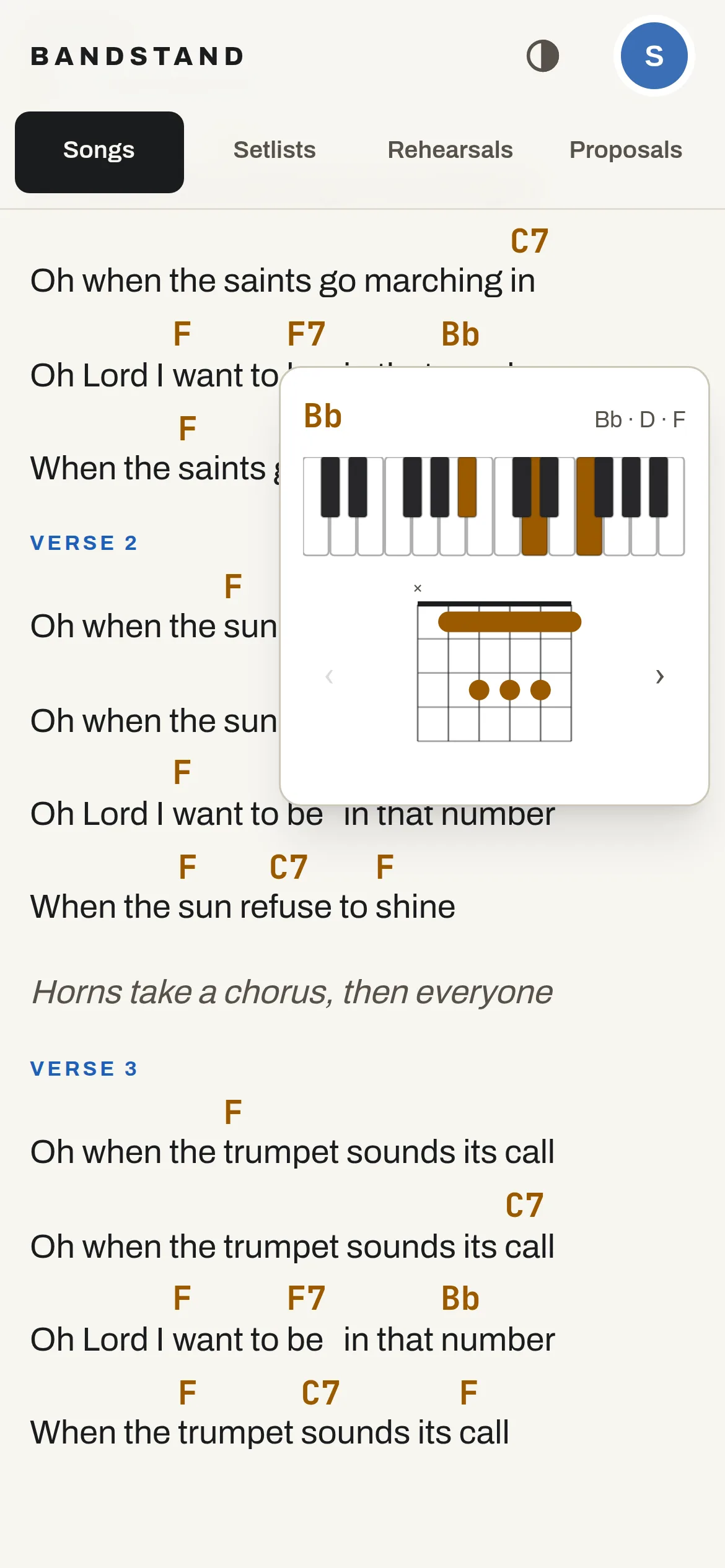 On a phone, a B-flat chord opened over the chart: its notes highlighted on a keyboard and a barre-chord fingering.